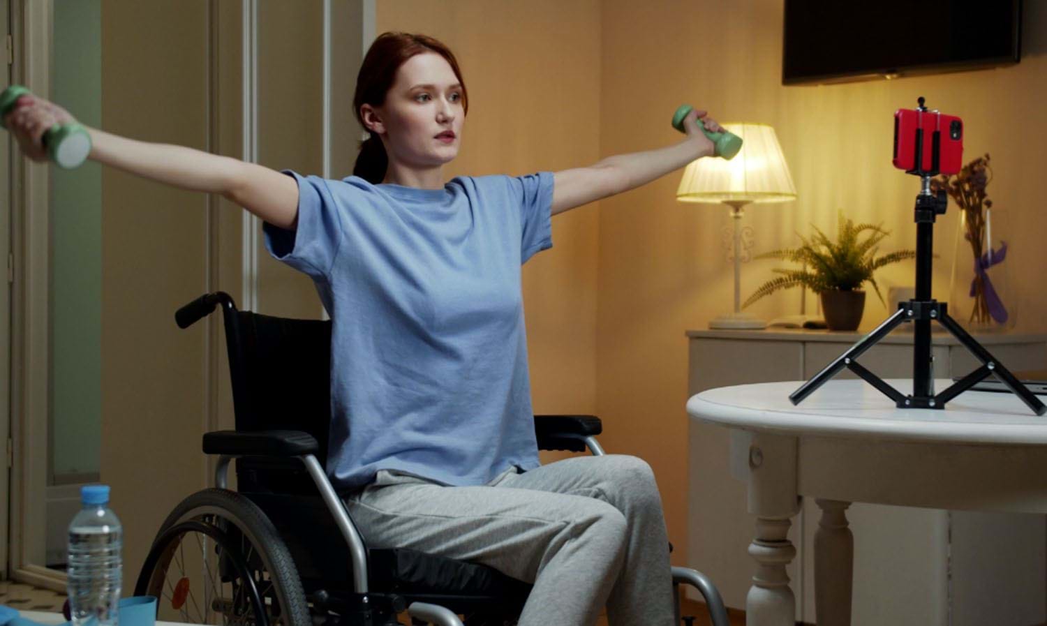 Lady in wheelchair with arms outstretched