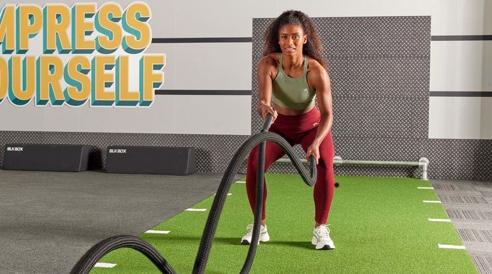 Lady working out with battle ropes